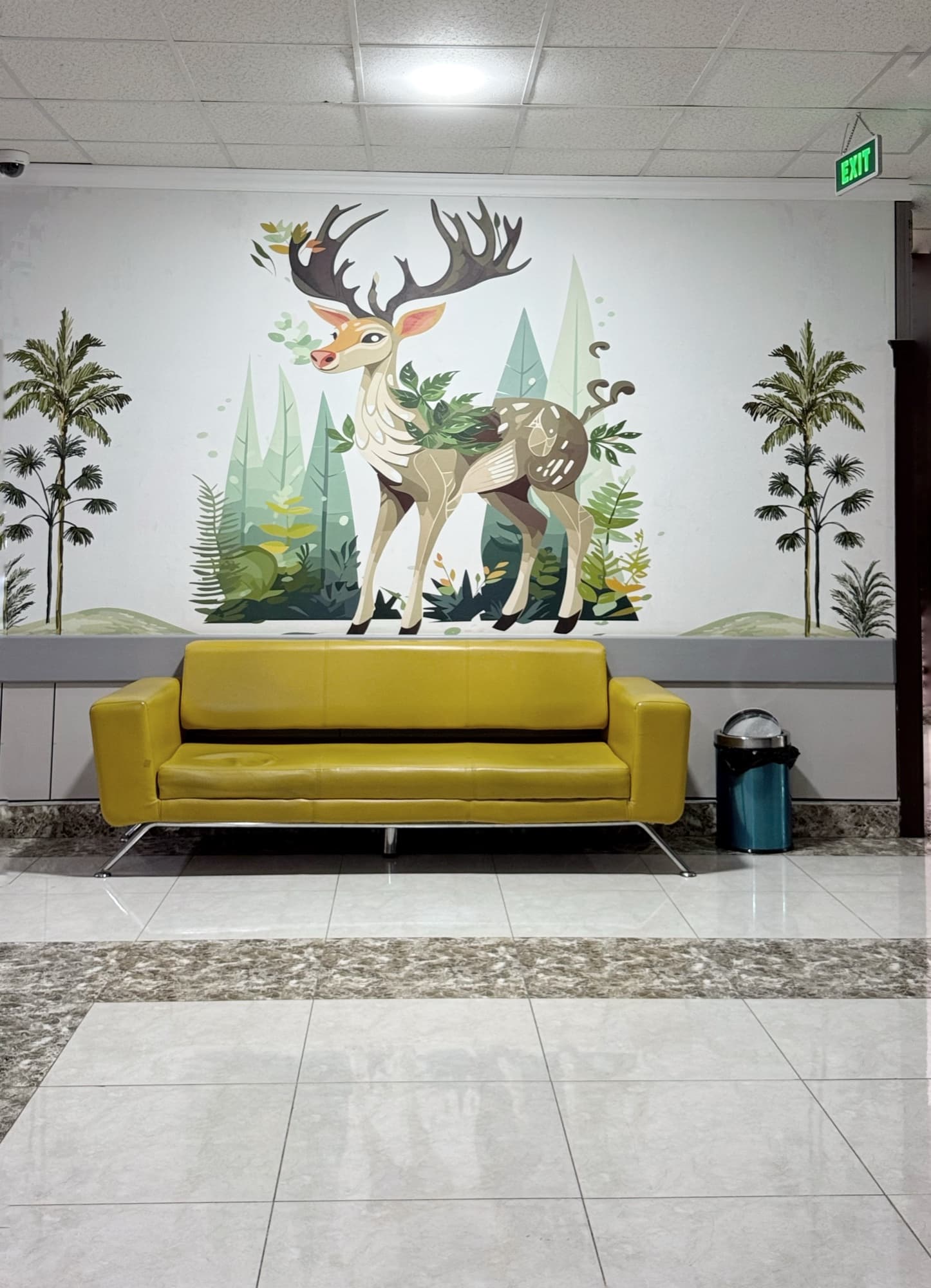 A comfortable waiting area with a decorative wall mural at Kurdistan Hospital